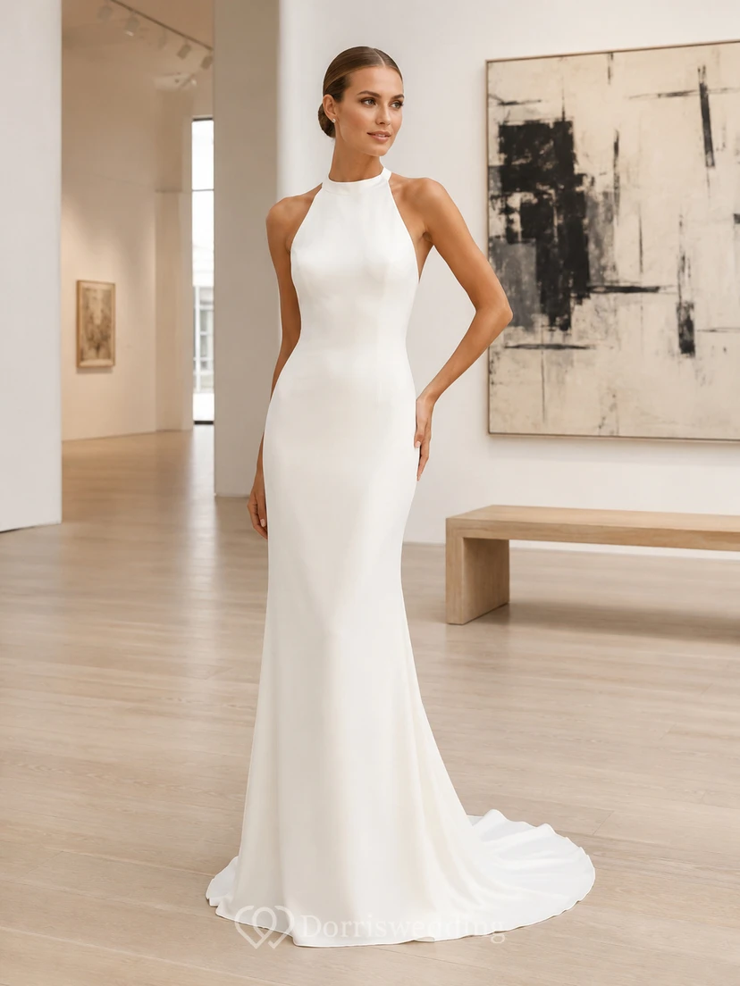 Vestido de novia de crepé ajustado con cuello alto, espalda descubierta y escote halter.