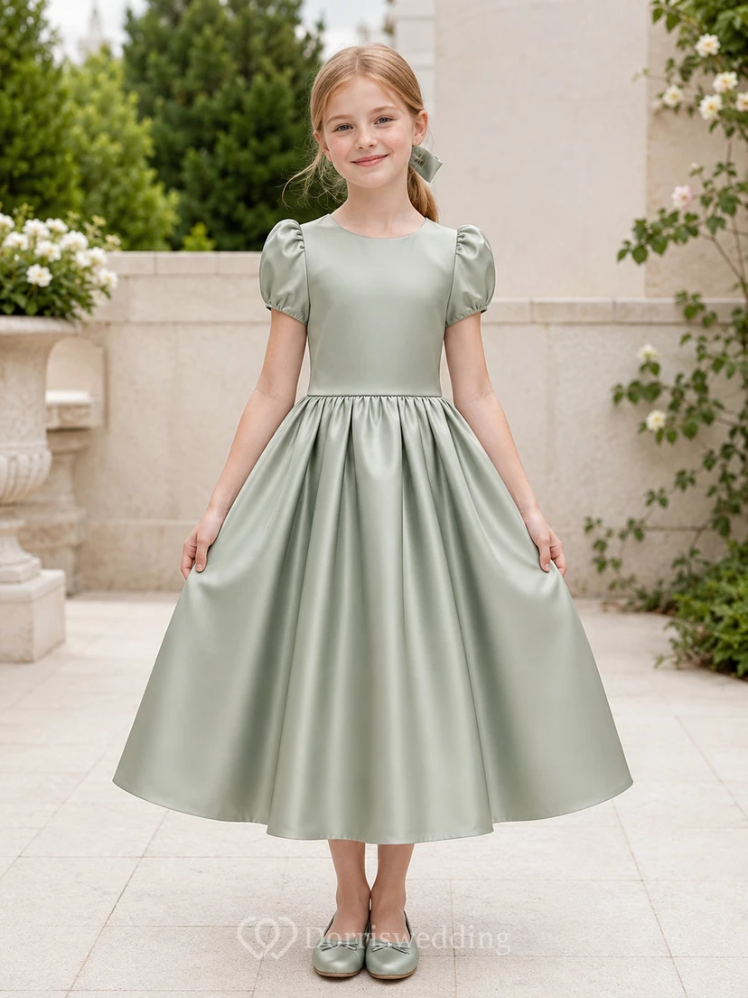 Robe de demoiselle d'honneur Sage Clean Line en satin, coupe trapèze, dos orné d'un nœud, manches bouffantes, col rond et jupe mi-longue.