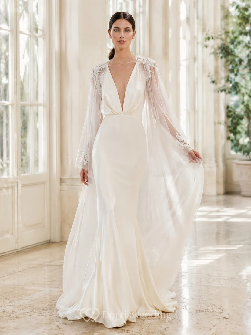 Robe de mariée de soirée en mousseline polie, décolleté en V profond, manches cape, coupe trapèze et traîne chapelle