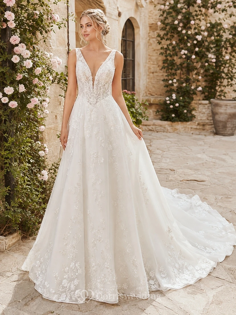 Vestido de novia de corte A con encaje y cintura estilo vasco, tirantes finos y punta puntiaguda, ideal para bodas al aire libre.