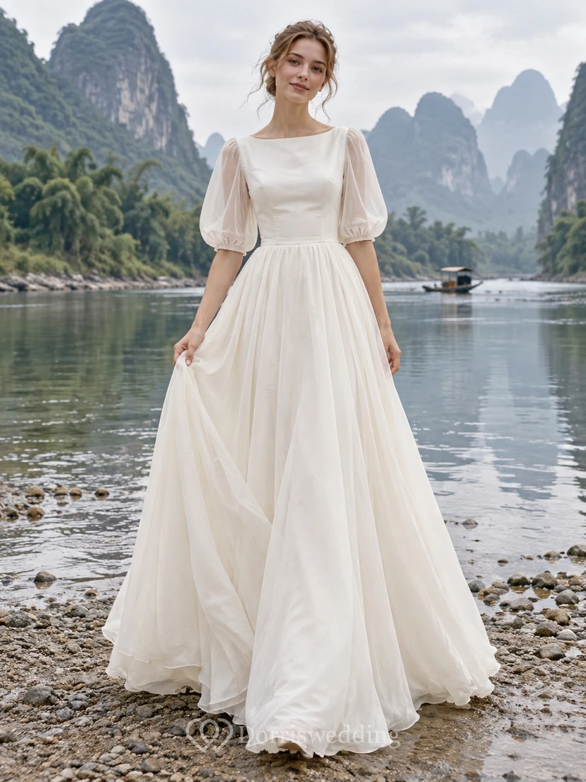Vestido de novia sencillo y modesto con escote barco, mangas abullonadas y corte en A.