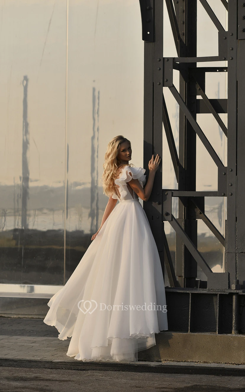 Robe de mariée vintage en mousseline de soie, manches bouffantes, traîne courte, ornée de perles et de volants, coupe bal. view 2
